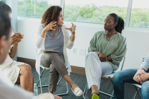 Two Women in a Group Therapy Setting