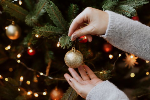 Woman Decorating a Christmas Tree